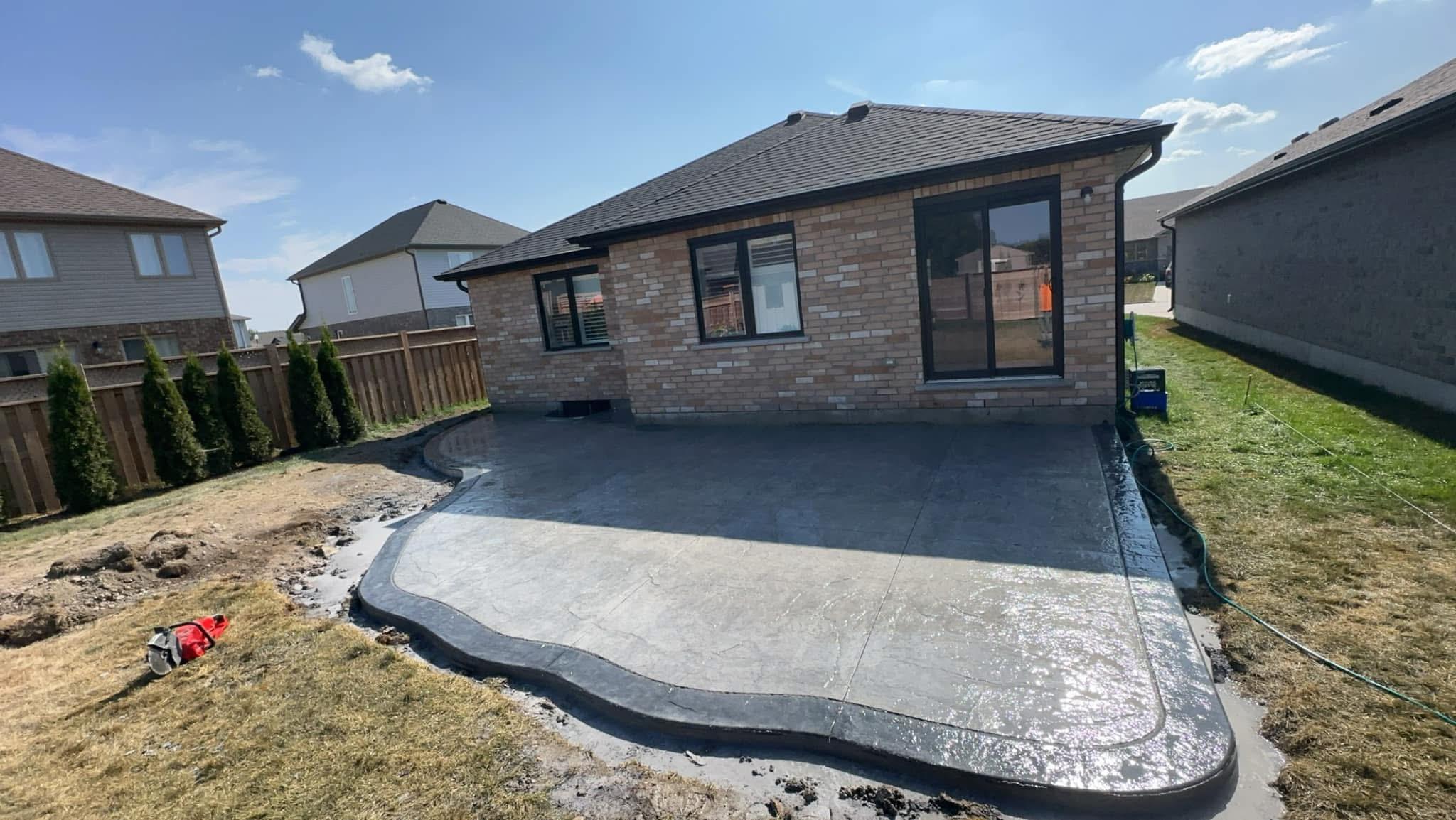Concept rendering — Curved stamped concrete patio with dark border
